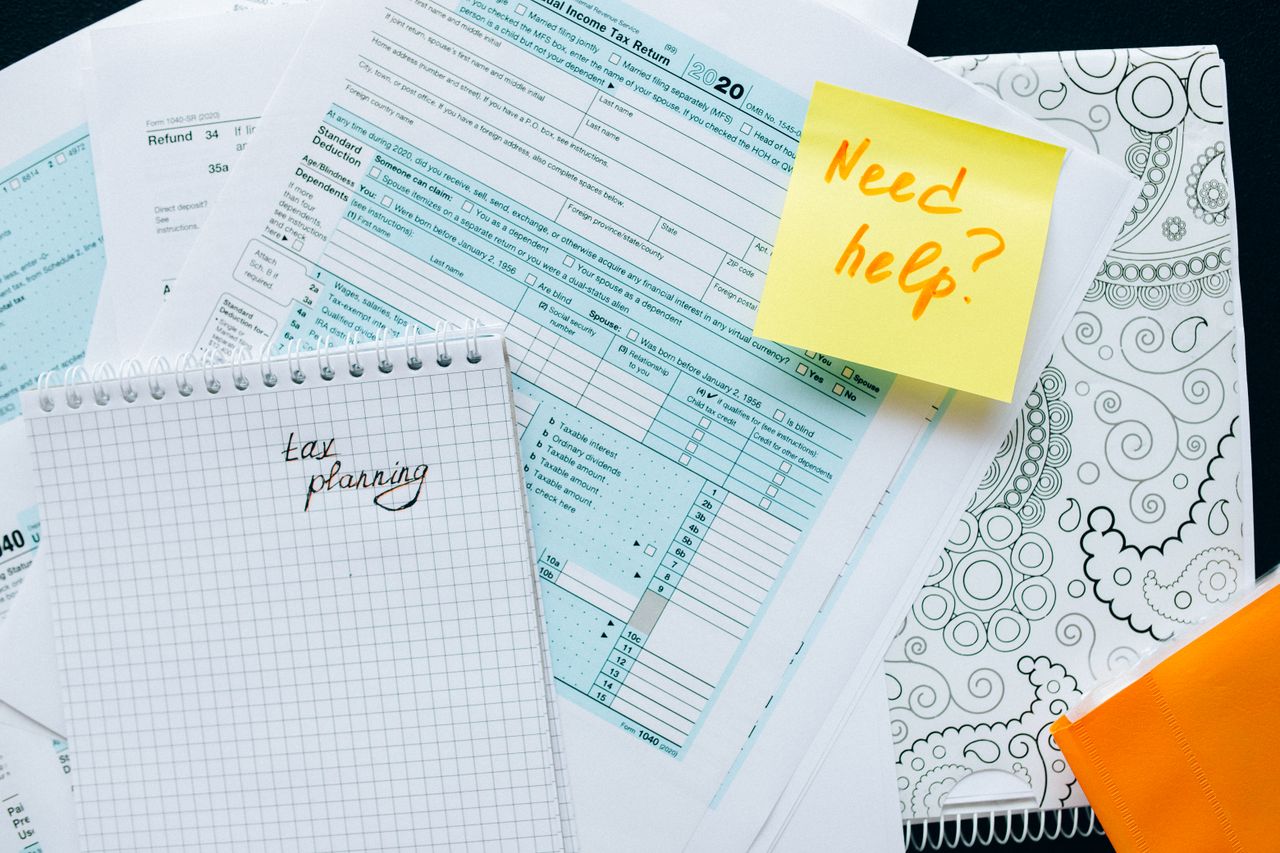 Crafting Captivating Headlines: Your awesome post title goes here Tax documents and a note suggest tax planning and assistance needs.